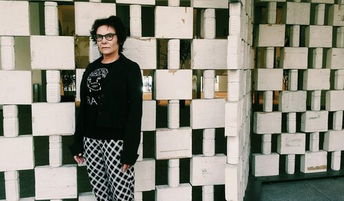 An image of director Salome Chasnoff, standing in front of a wall.